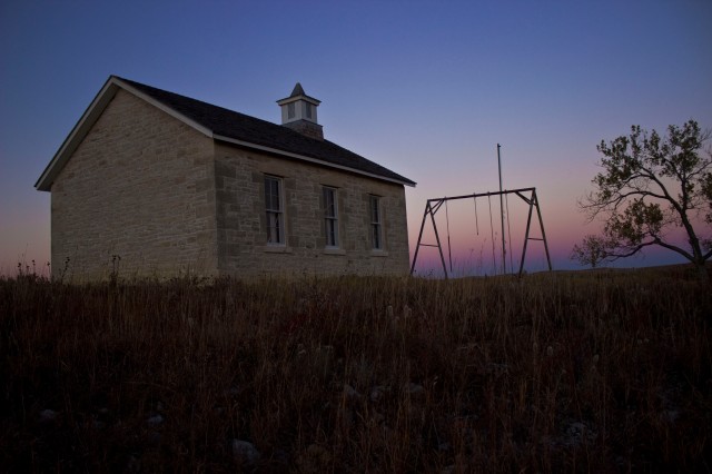 This abandoned school in the Tallgrass Prairies of Kansas gives way to night as the sunsets.