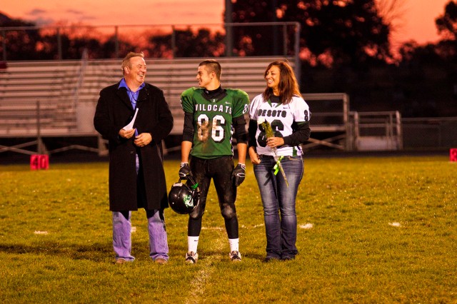 My boss, his son and his wife share a moment before the senior's final high school football game in late October.